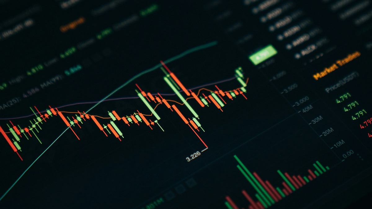Financial trading screens showing market data charts