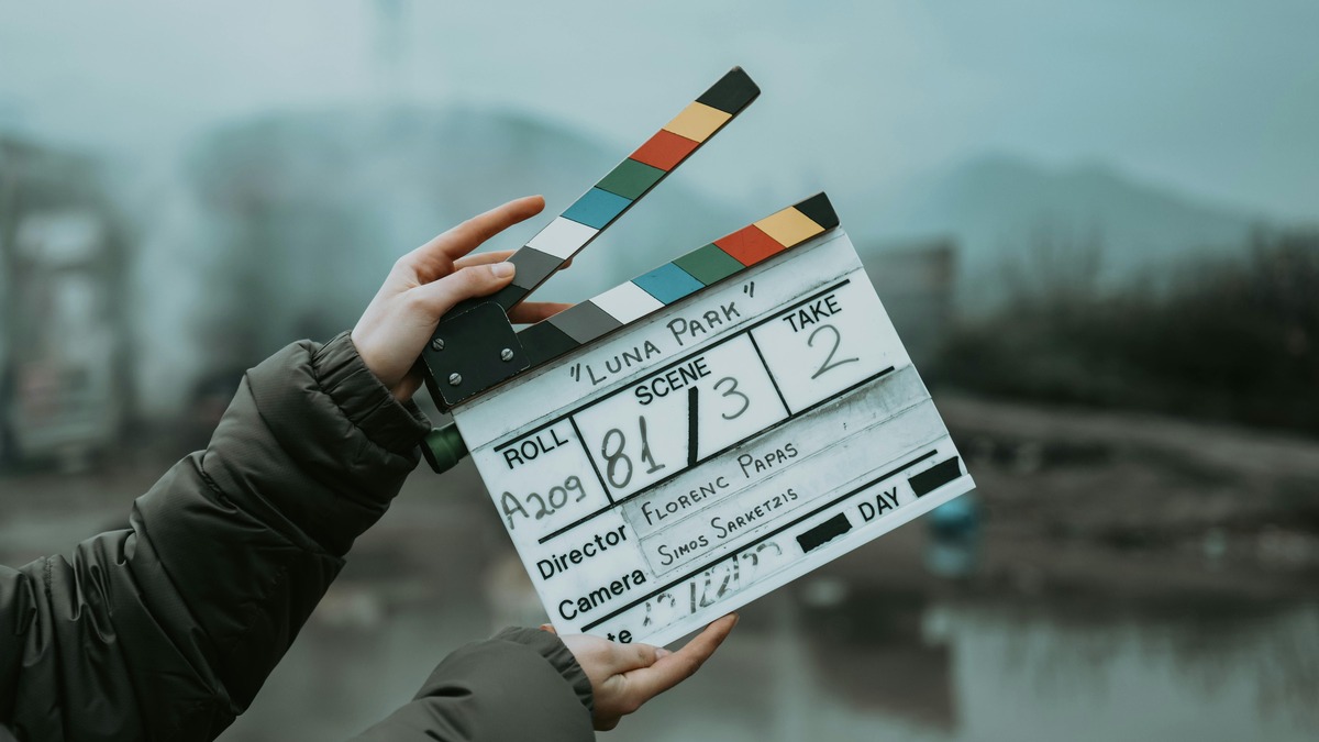A film clapperboard on an outdoor set, marking the start of a scene