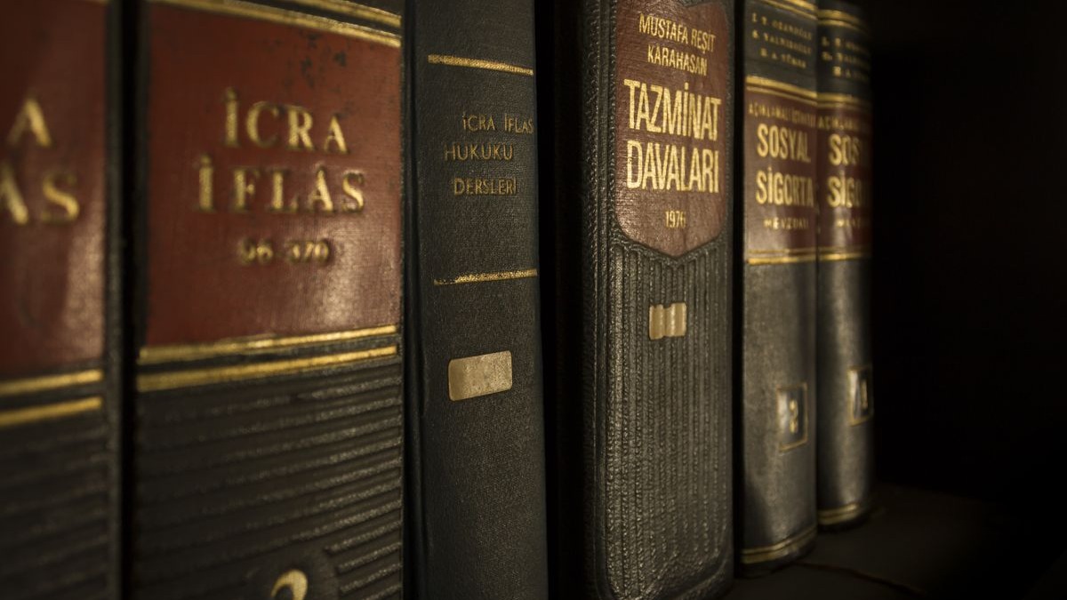 A stack of legal books with annotated statutes and handwritten notes