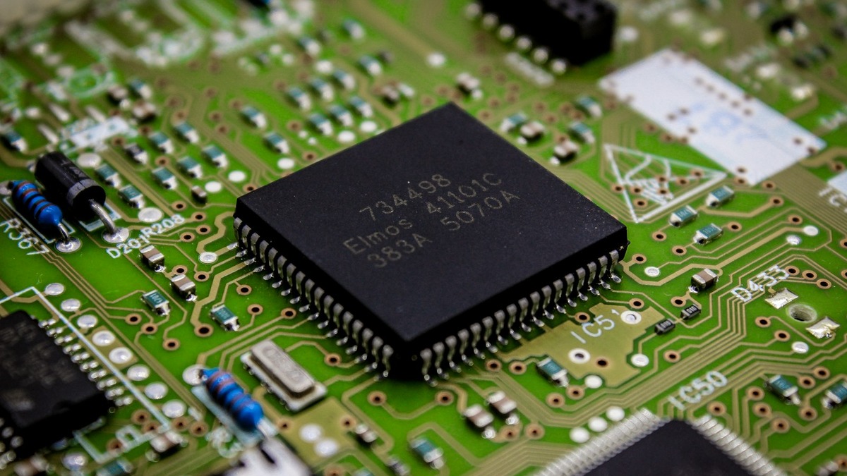Close-up of a processor chip on a green circuit board