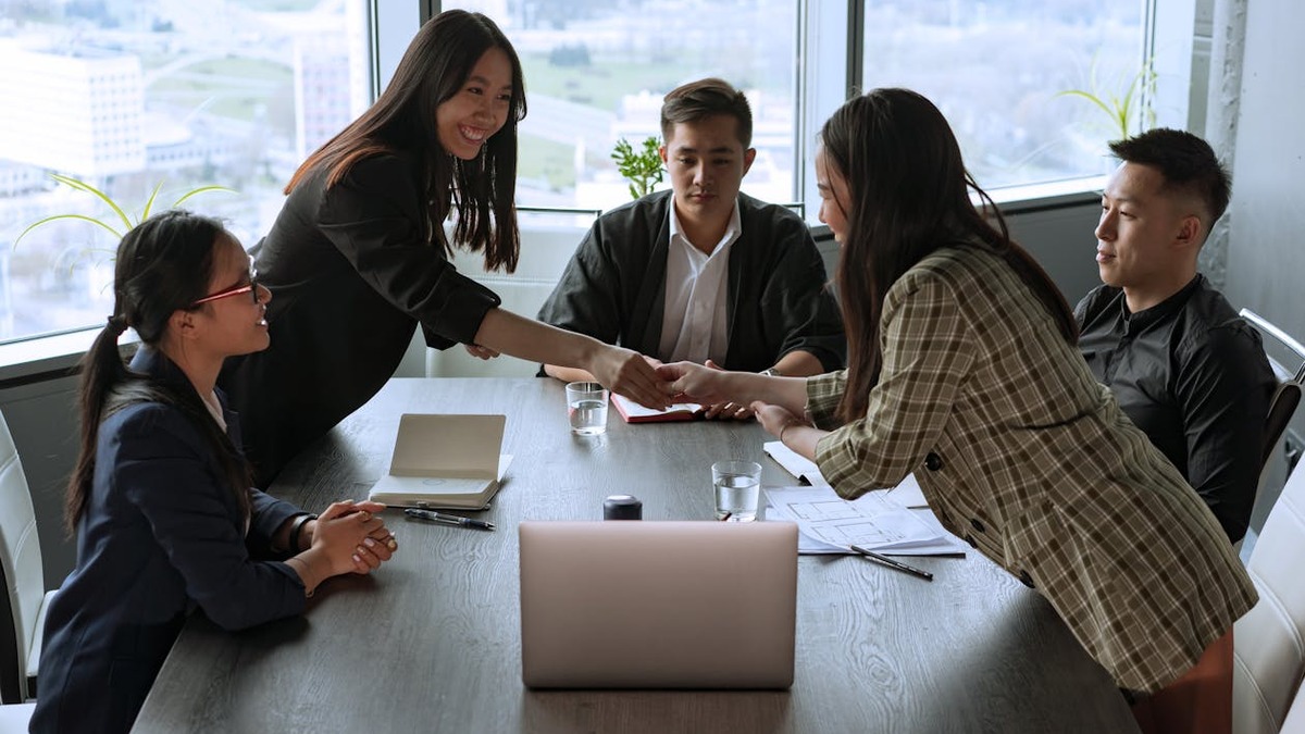 Diverse group of people gathered in a meeting around a table