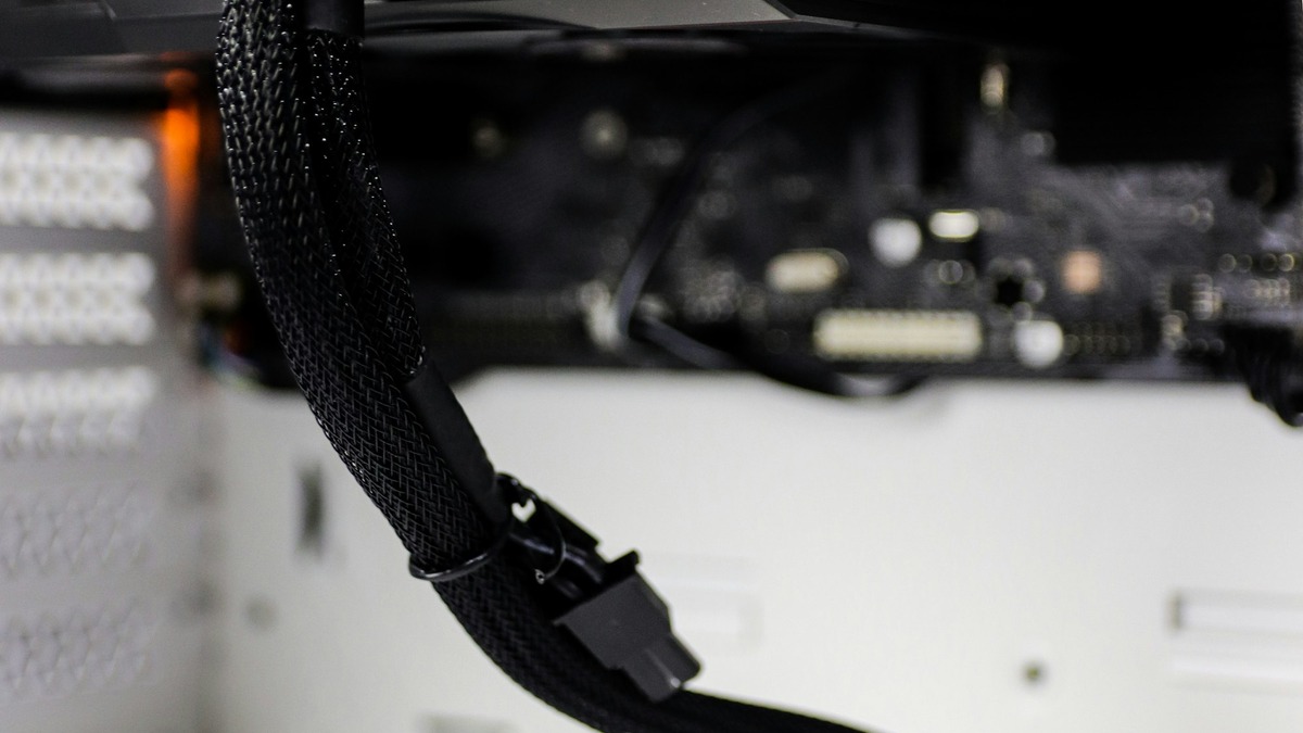 A GPU installed inside a desktop tower, cables routed to its power connector