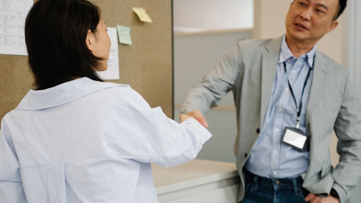 Two colleagues shaking hands to seal a deal