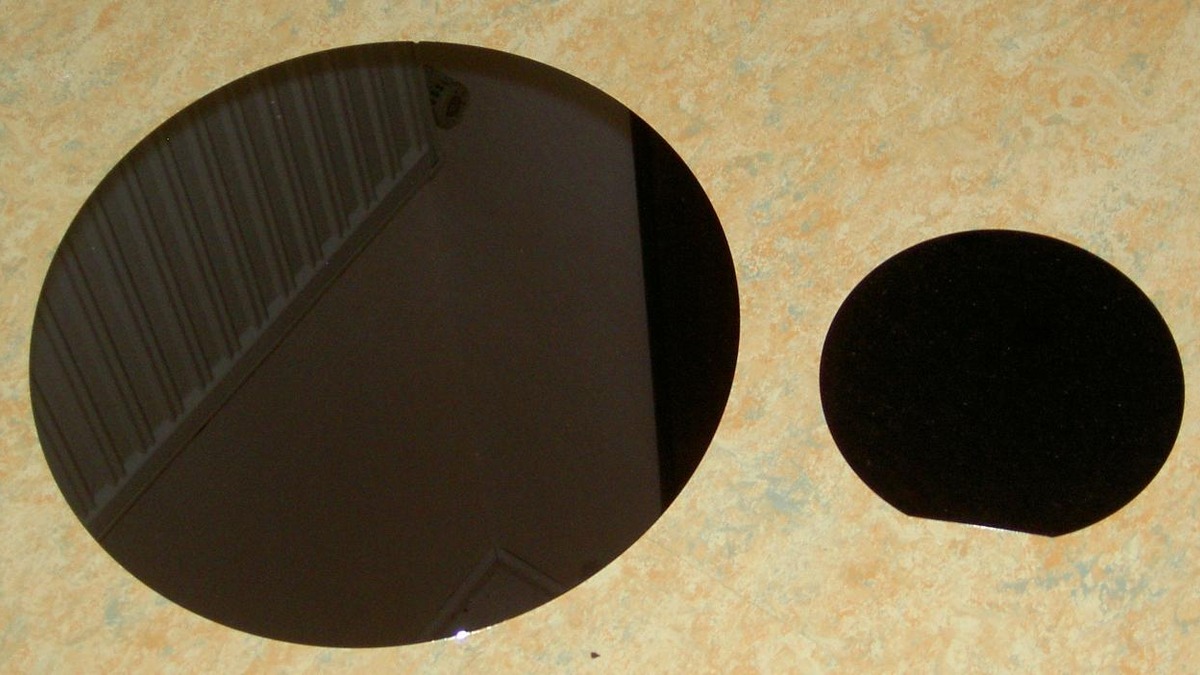 A polished silicon wafer reflecting light before it enters the fab process