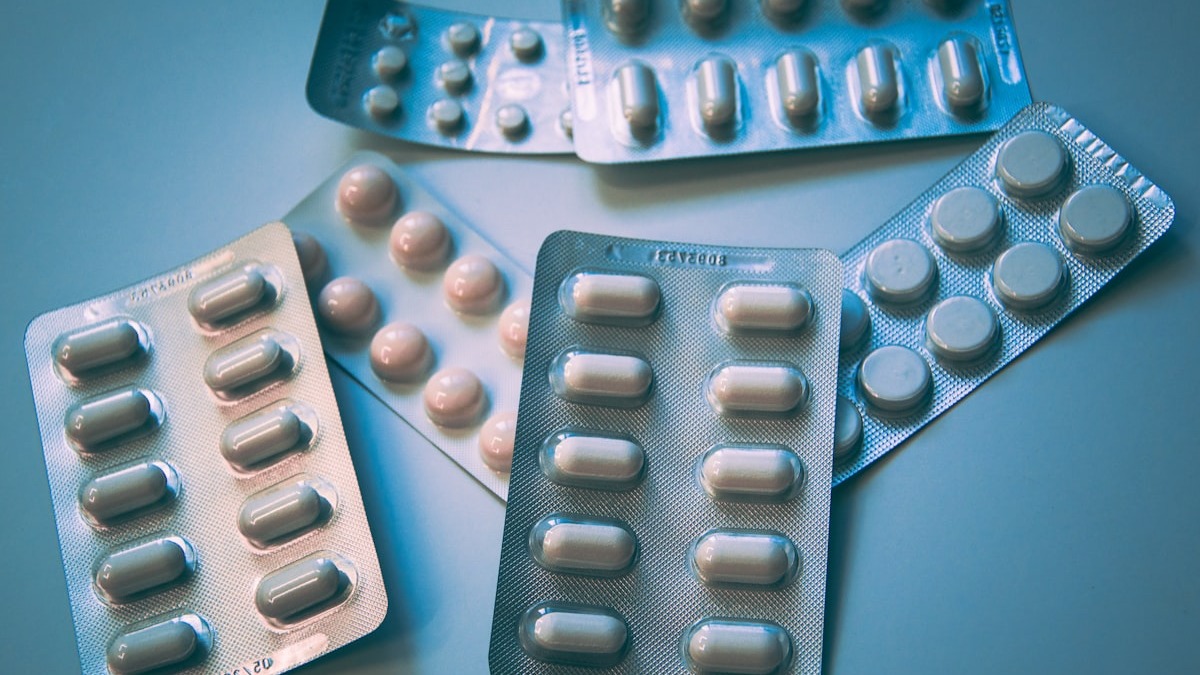 Prescription medication bottles lined up at a pharmacy