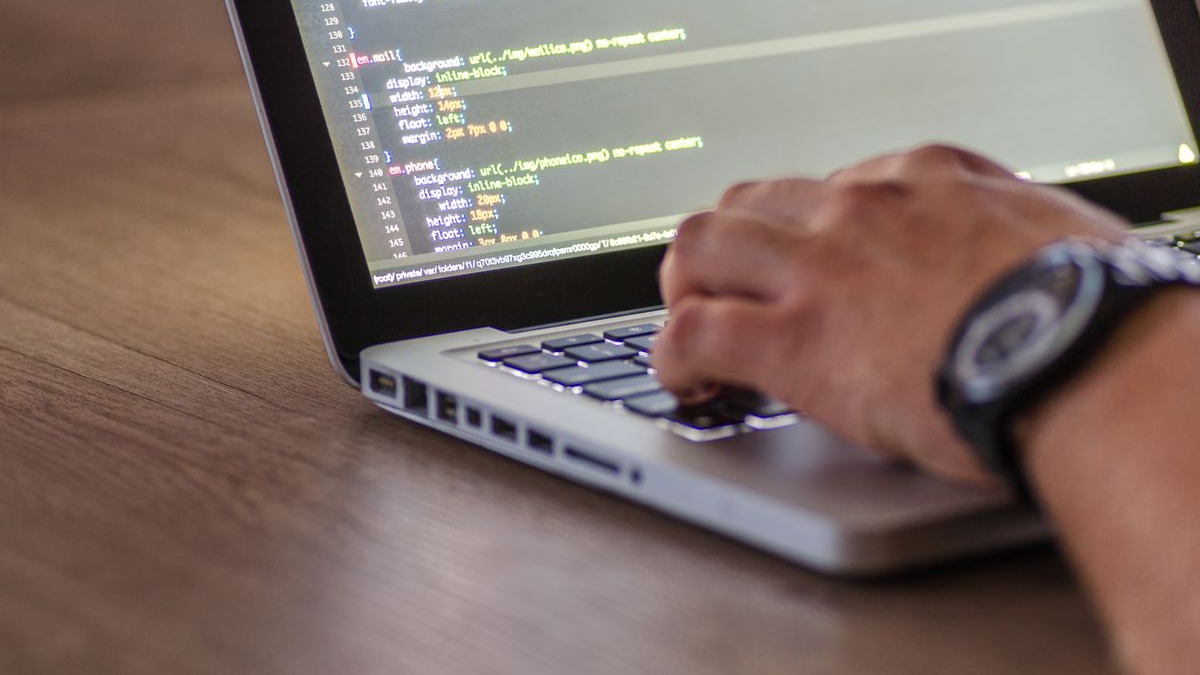 A developer working at a computer with code on screen
