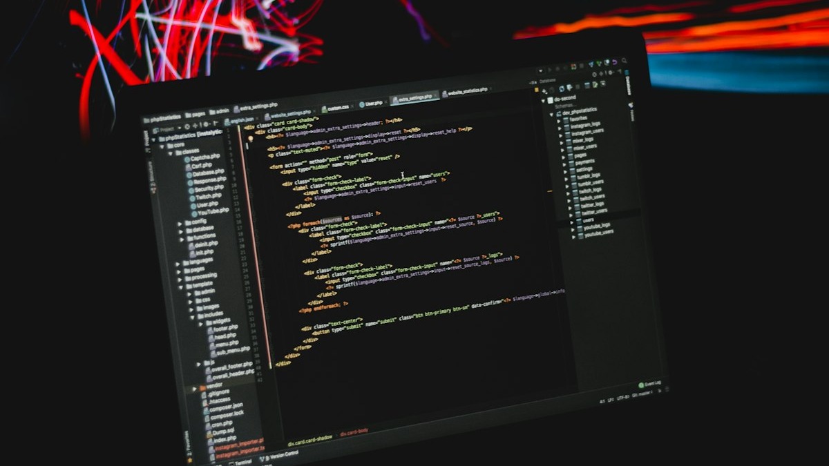 A developer working with code on a laptop