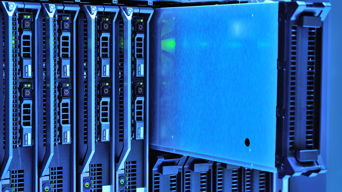 Rows of illuminated server racks in a data center