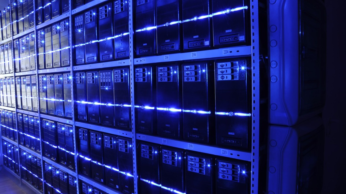 Rows of server racks with blue indicator lights in a data center
