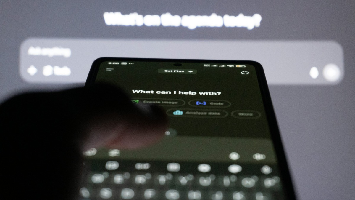 Person typing on a smartphone with an AI chatbot interface showing suggested prompts