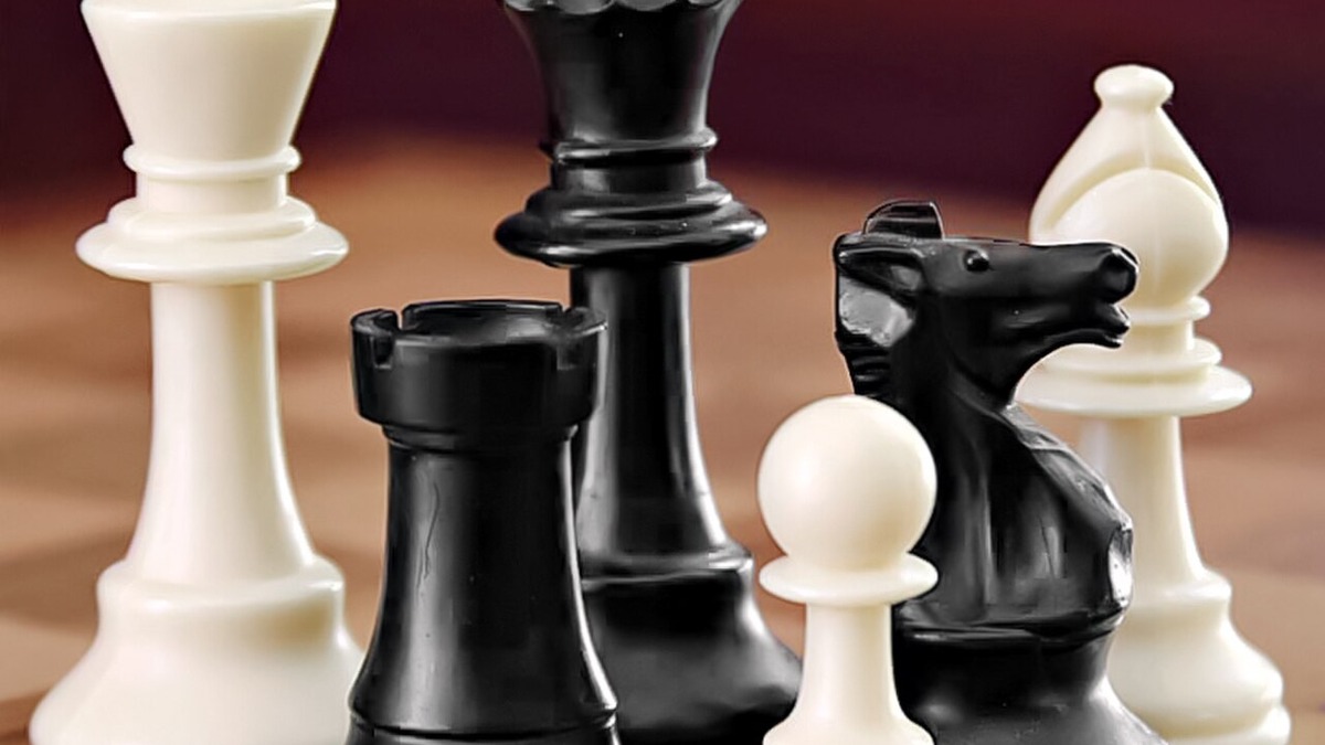 A chess board set up for competitive play between two opponents