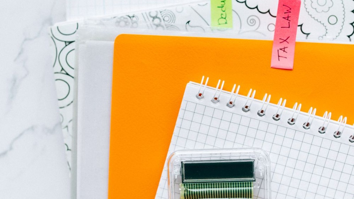Clipboard with a checklist and pen on a white background