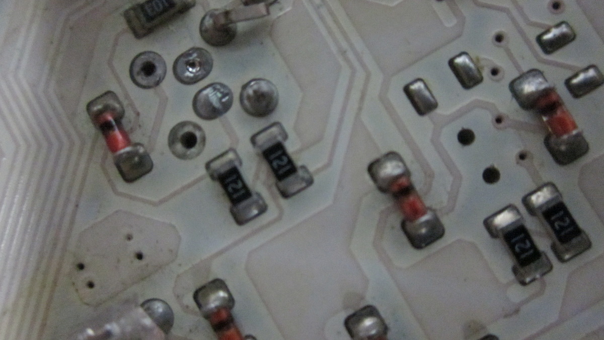 A white printed circuit board with electronic components, representing the layers and memory structures of transformer attention