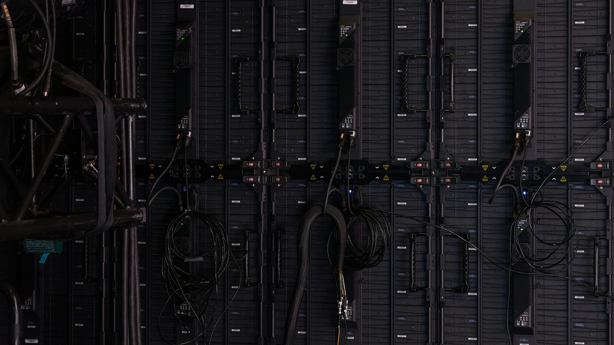 Overhead view of dark server rack units with cables running between them