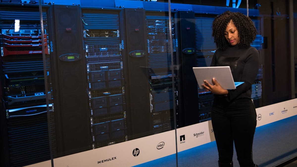 A software engineer working at a server rack, representing the engineering behind agentic systems