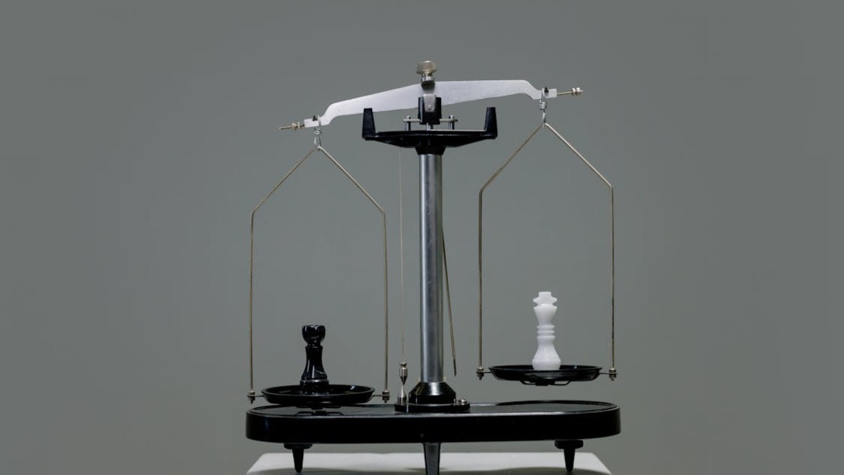 Chess pieces balanced on a brass scale