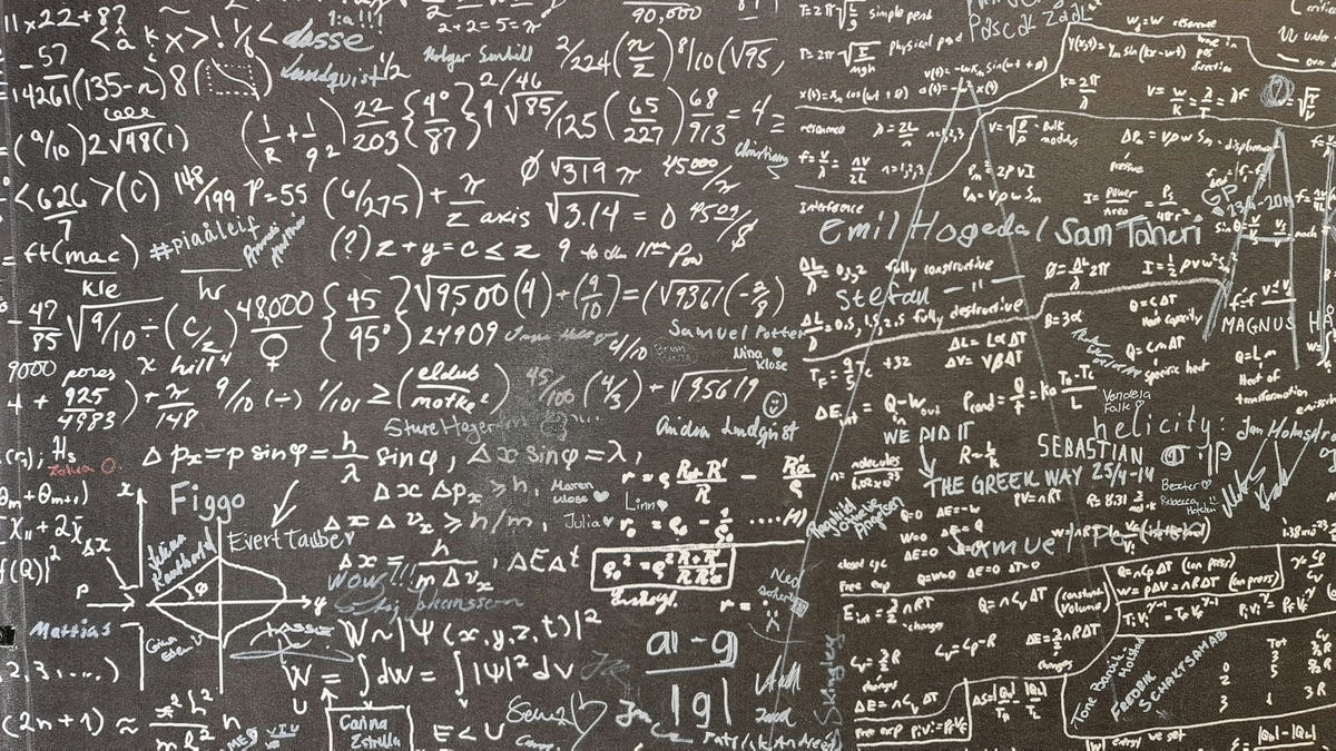 Mathematical equations filled across a blackboard