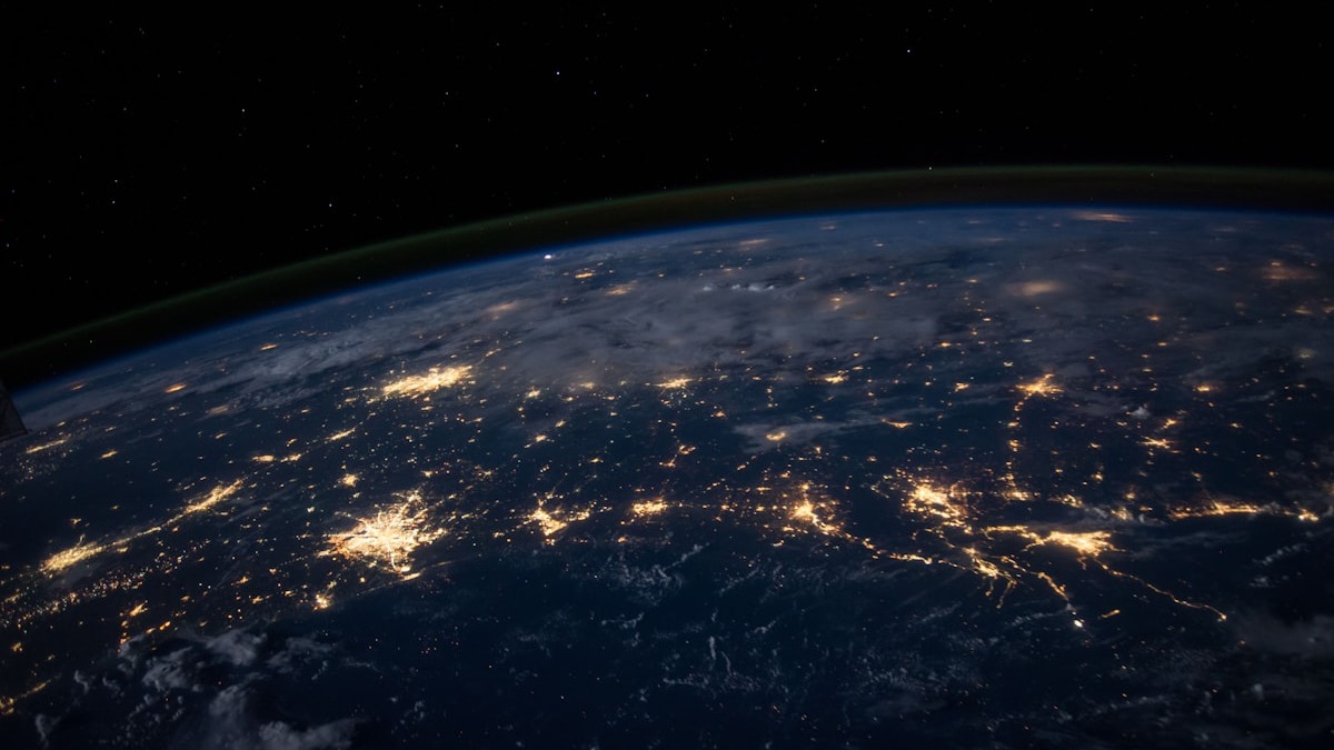 Abstract visualization of a data network with interconnected nodes glowing against dark space