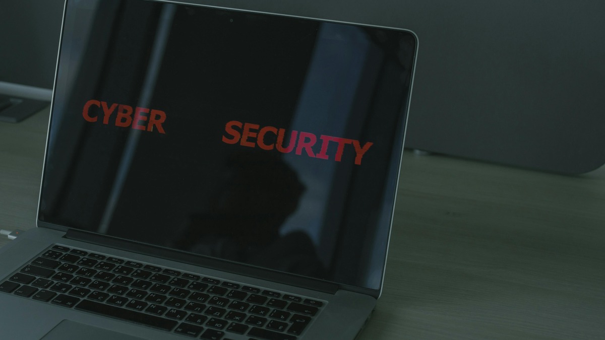 A padlock resting on a laptop keyboard, representing digital security and access control