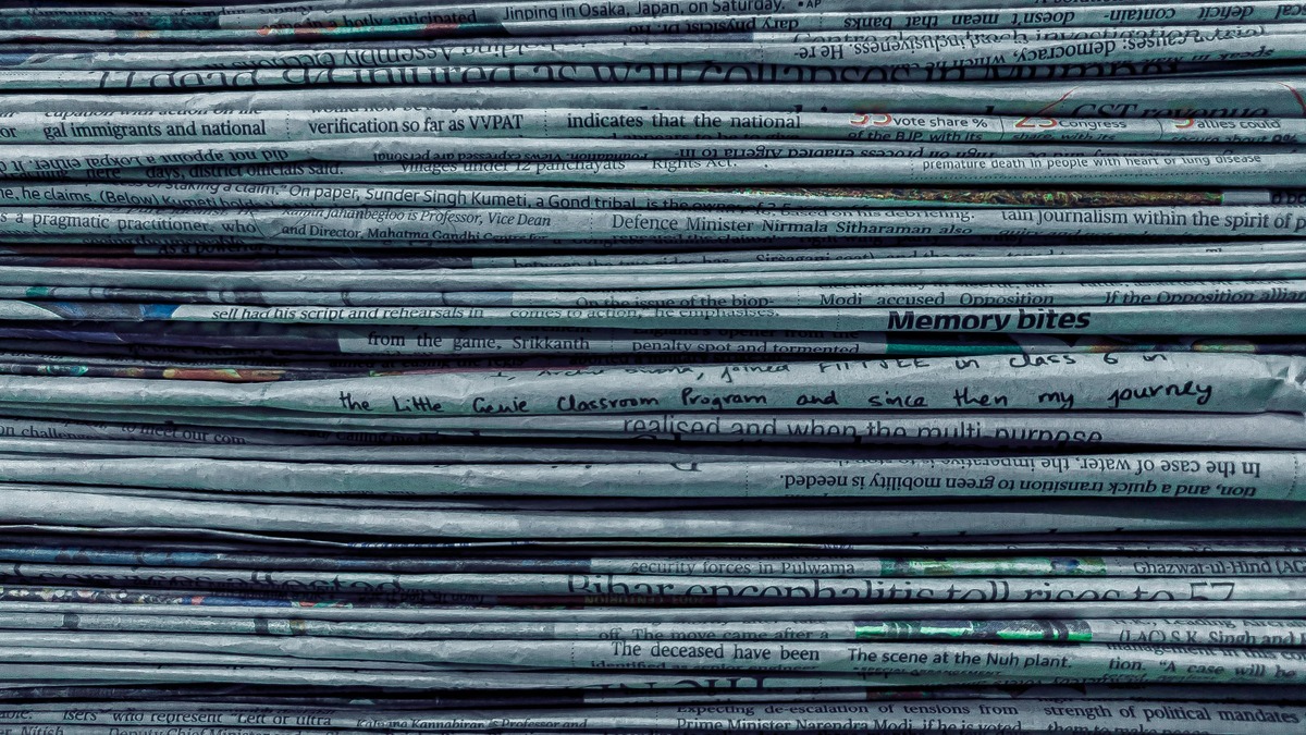 A stack of old folded newspapers