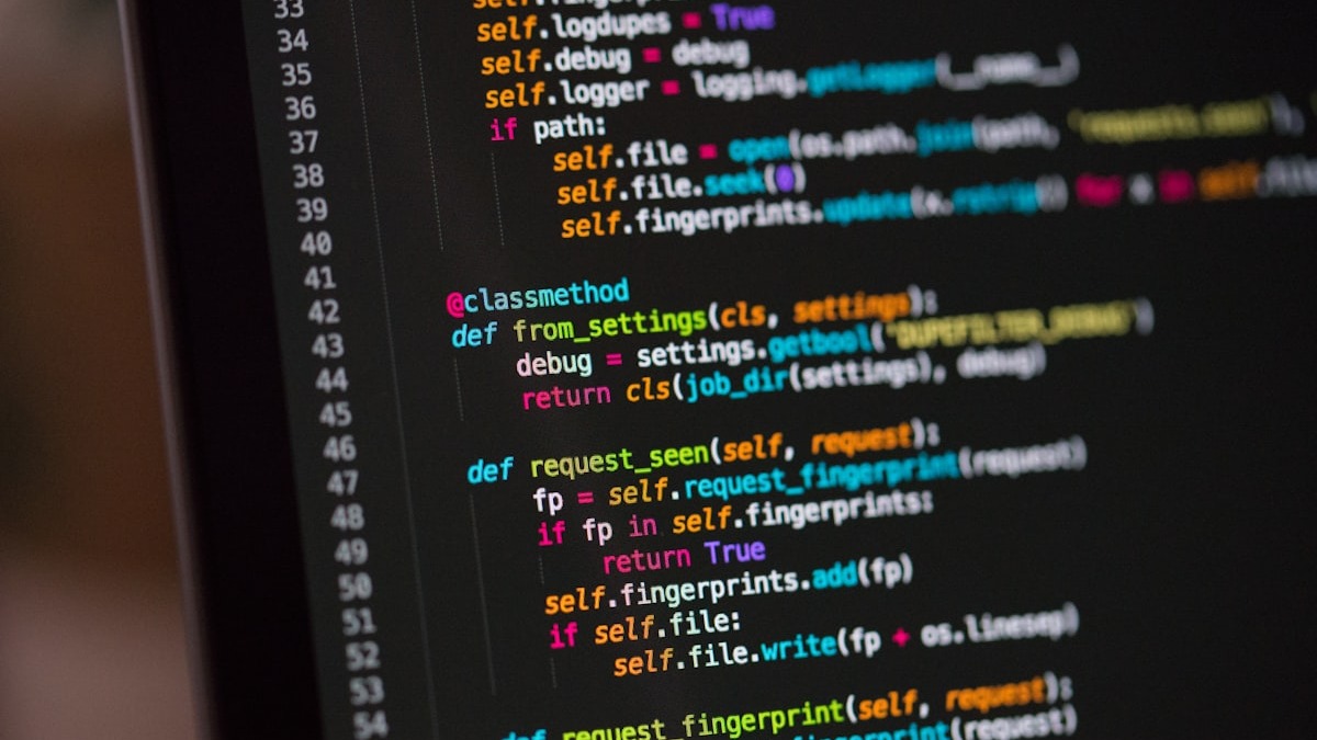 Colorful source code on a computer screen representing the LLM reasoning layer in vision-based automation
