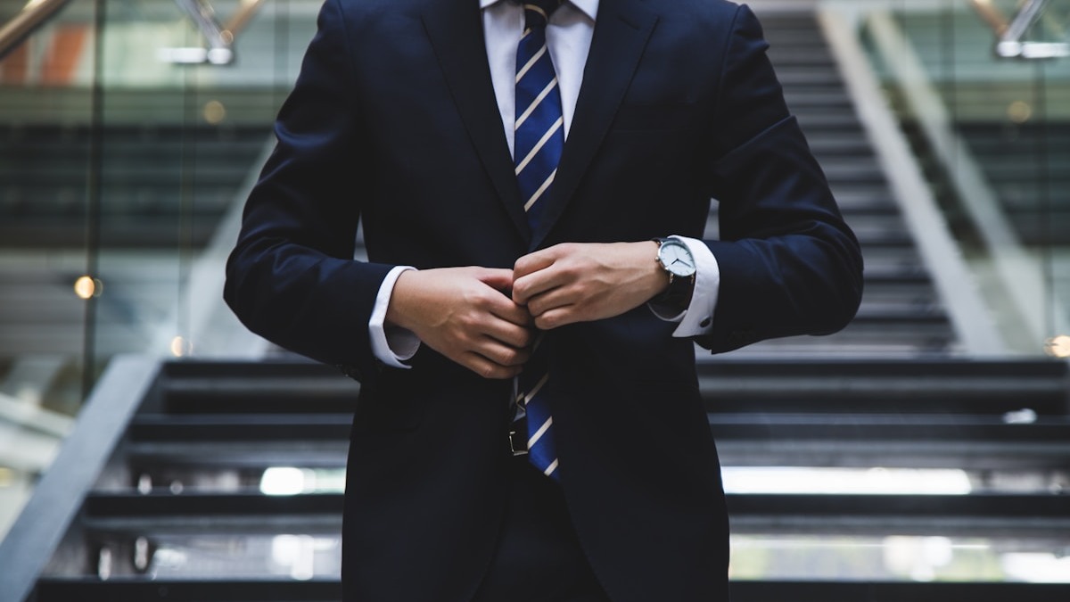 A professional in a business suit reviewing printed documents