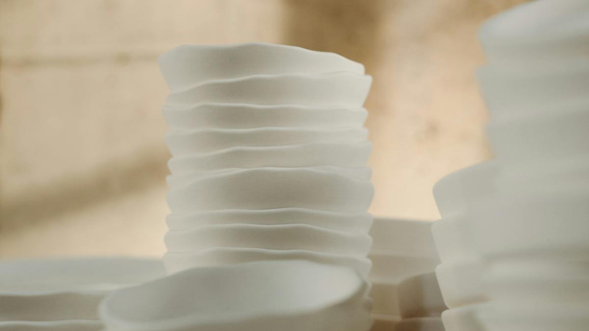 A creative workspace with colorful paint supplies and design materials spread across a table