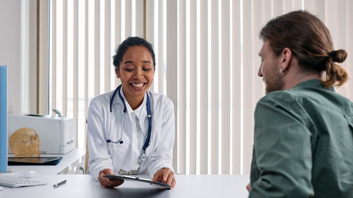 A doctor reviewing patient information on a tablet device