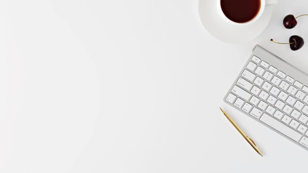 Writer working at a desk with a laptop and coffee cup