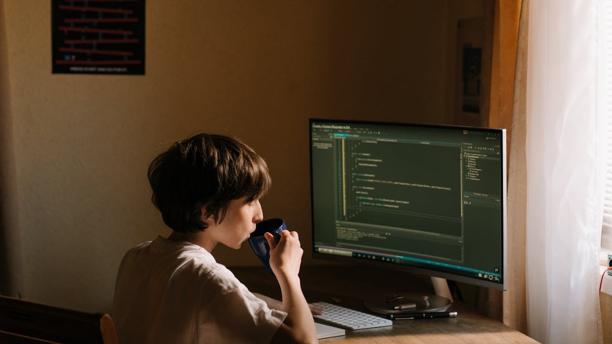 Developer writing code on a laptop during an evening session