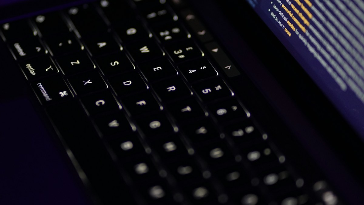 Developer reviewing code on laptop during agentic workflow